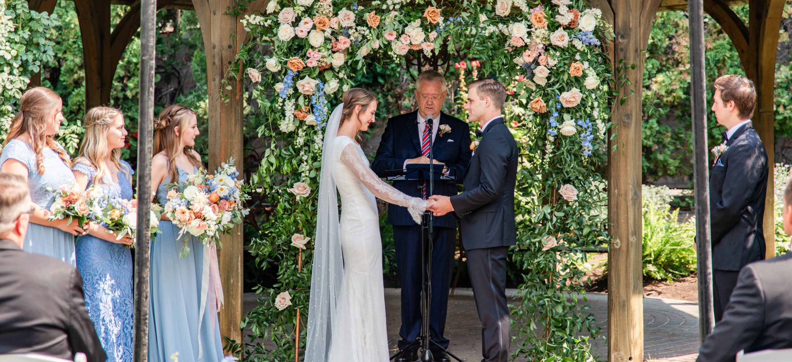 wedding ceremony with floral backdrop