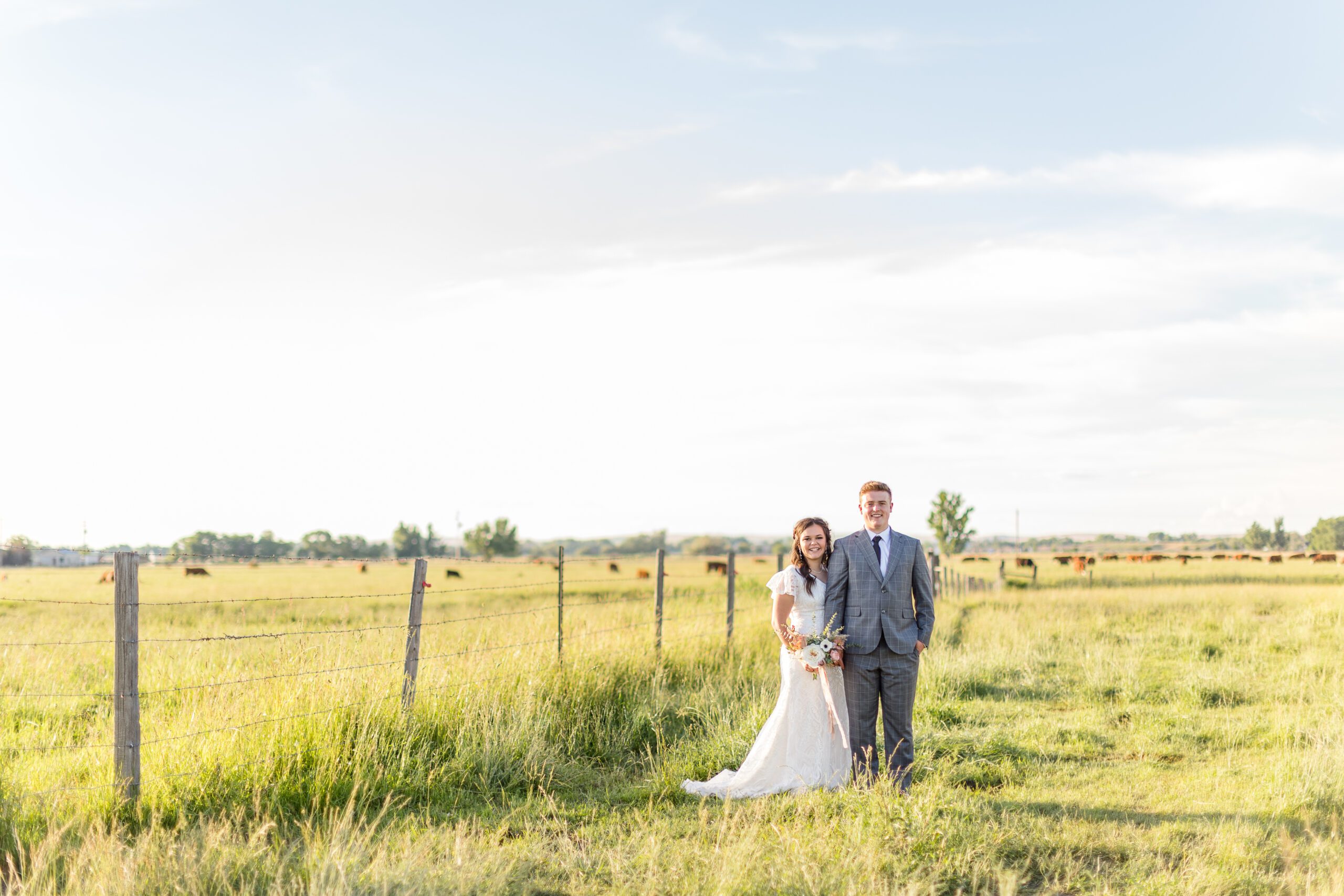 bride and groom in a green field